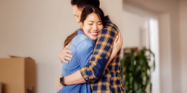 Chinese couple hugging in a new home in Summerlin